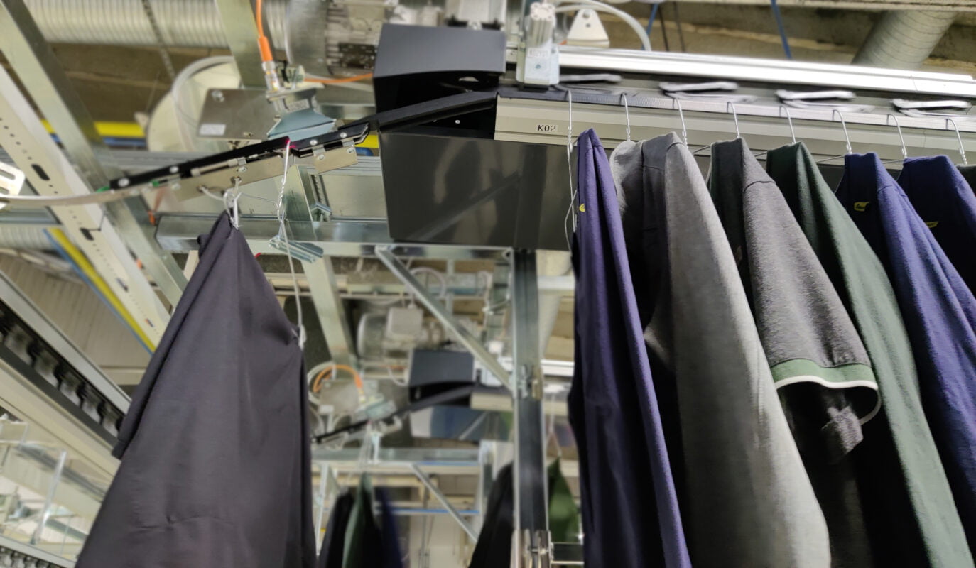 Garments been paced by a clip conveyor.